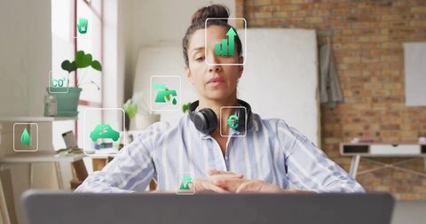 Remote worker analyzing green data icons in modern studio
