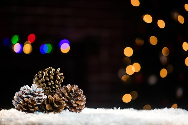 Pine Cones on Snow with Christmas Lights Bokeh - Download Free Stock Photos Pikwizard.com