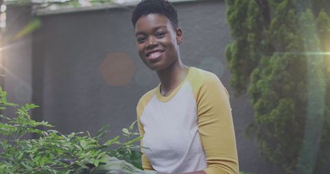 African American Woman Gardening with Sun Flare