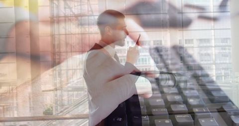 Businessman in Warehouse with Technology Overlay Concept