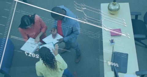 Collaborative team reviewing digital technology at office table