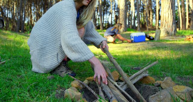 Women Setting Up Campfire in Forest Clearing - Download Free Stock Images Pikwizard.com