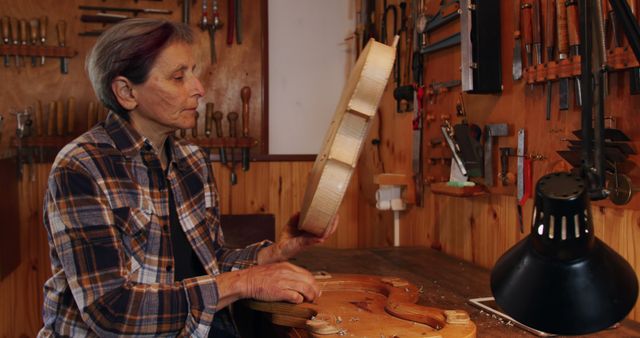 Senior Woman Crafting Violin in Workshop - Download Free Stock Images Pikwizard.com