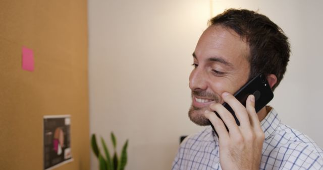 Smiling Man in Office Talking on Smartphone - Download Free Stock Images Pikwizard.com