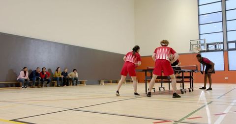 Diverse players competing in intense table tennis match