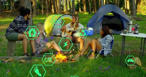 Friends Enjoying Music and Camping in Pine Forest Clearing