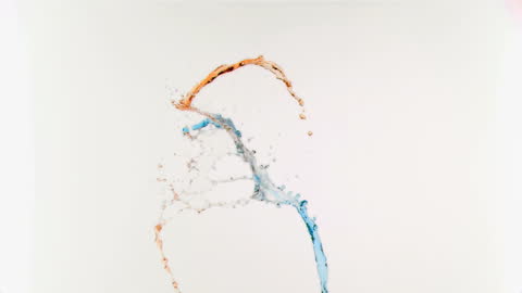 Vibrant Blue and Orange Liquid Splashing in Air