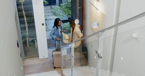 Couple arriving home unpacking in modern interior