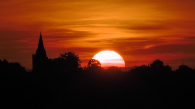 Dramatic Sunset with Silhouette of Trees and Building Spire - Download Free Stock Photos Pikwizard.com