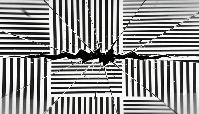 Broken glass impact on calibration chart with radial cracks, monochrome high-contrast