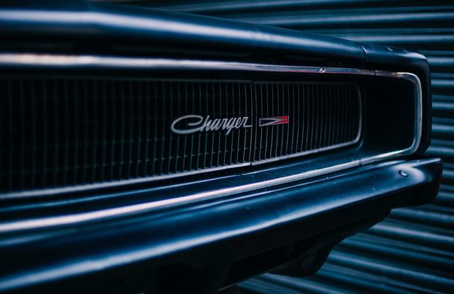 Close-Up of Classic Muscle Car Grille with Dodge Charger Emblem - Download Free Stock Photos Pikwizard.com