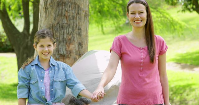 Mother Holding Daughter's Hand at Park on Sunny Day - Download Free Stock Images Pikwizard.com