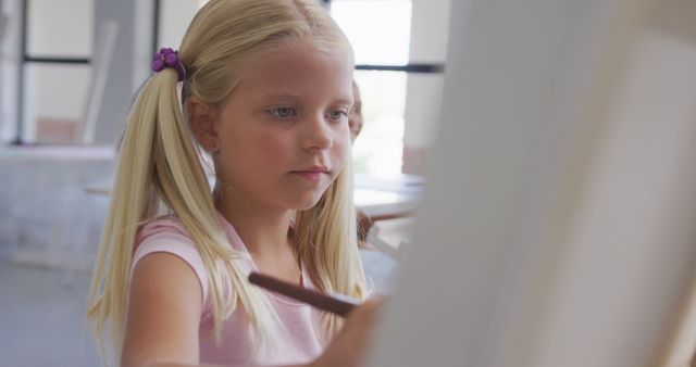 Young Girl Concentrating on Painting in Art Class - Download Free Stock Images Pikwizard.com