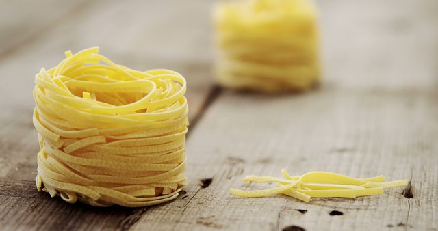 Fresh Uncooked Tagliatelle Pasta Nests on Rustic Wooden Table - Download Free Stock Images Pikwizard.com