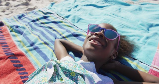 Young Girl Relaxing on Beach with Sunglasses and Colorful Towels - Download Free Stock Images Pikwizard.com