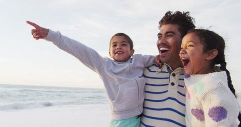 Joyful Family Bonding by the Ocean at Sunset