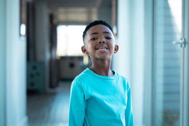 African american boy smiling at camera in hallway - Download Free Stock Photos Pikwizard.com