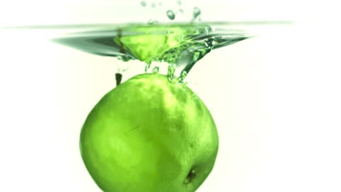 Vibrant Green Apple Splashing in Water