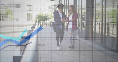 Young professionals walking, checking smartphone with analytics overlay on urban walkway