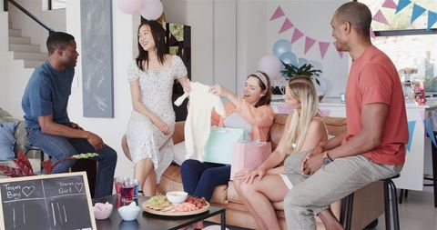 Diverse Friends Celebrating Baby Shower in Vibrant Living Room