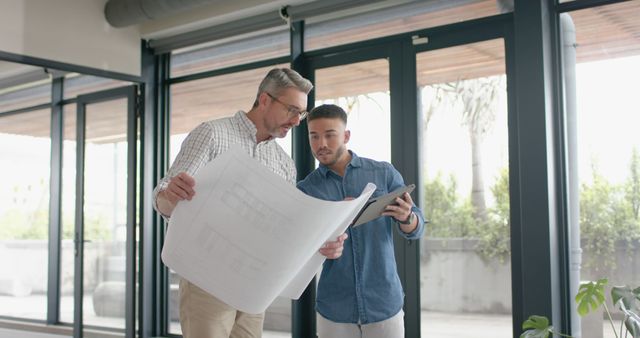 Two Architects Discussing Building Plans in Modern Office - Download Free Stock Images Pikwizard.com