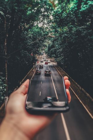 Creative perspective of road seen through smartphone