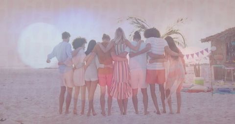 Friends Linking Arms on Beach at Sunset