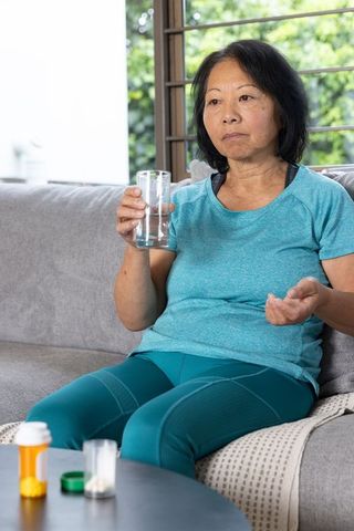 Senior Woman in Fitness Attire Discussing Health at Home