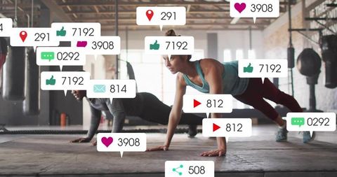 Fitness partners performing plank workout in industrial gym with social media overlays