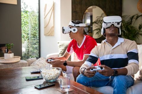 Diverse Friends Playing Virtual Reality Game in Modern Living Room