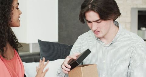 Happy Couple Exchanging Gifts During Anniversary Celebration