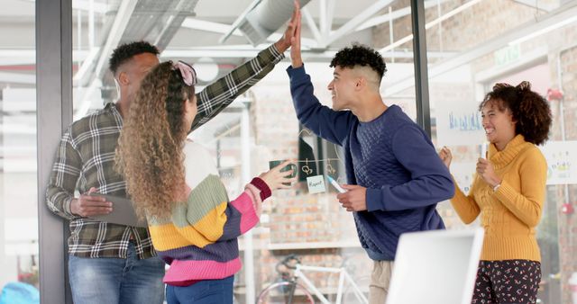 Diverse Colleagues Celebrating Success with a High-Five in Modern Office - Download Free Stock Images Pikwizard.com