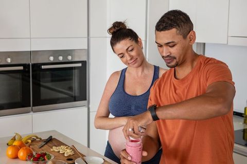 Healthy-Diverse Couple Making Smoothies in Modern Kitchen