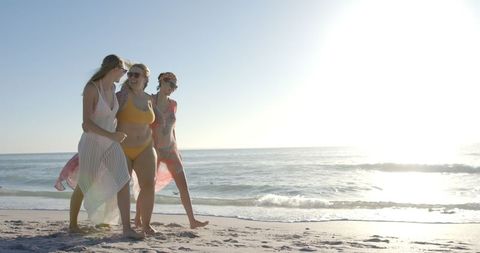 Young Women Enjoying Sunny Beach Day Vibrant Atmosphere - Download Free Stock Images Pikwizard.com