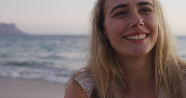 Smiling Woman Enjoying Beach during Sunset - Download Free Stock Images Pikwizard.com