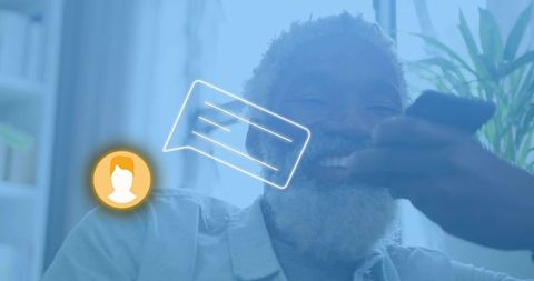 Smiling senior african american man video calling on smartphone with glowing chat overlay