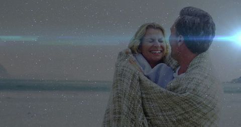 Couple Sharing Intimate Moment Wrapped in Blanket Relishing Beachtime Serenity