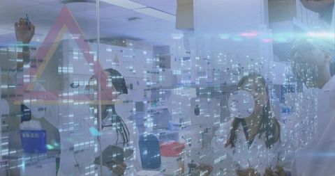 Collaborating scientists pointing at glass partition with digital data overlay in laboratory