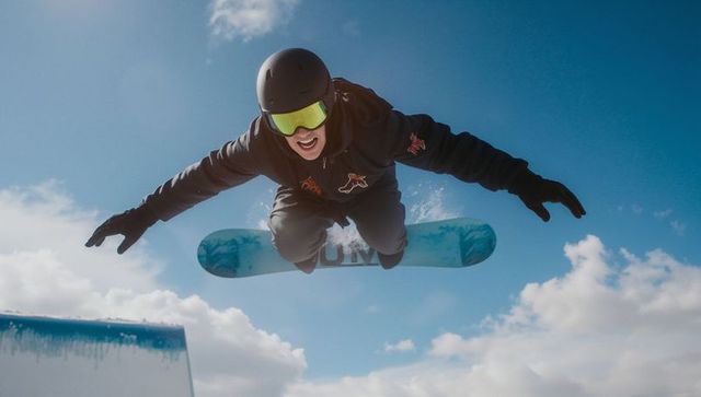 Snowboard Athlete Daring Jump on Blue Sky Winter Day