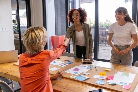 Diverse Women Engaged in Creative Teamwork Session