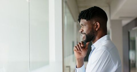 Confident professional contemplating success in modern office