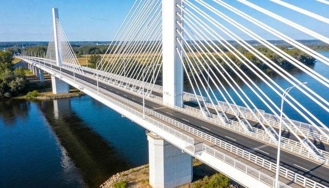 Modern Cable-Stayed Bridge Spanning River with Central Pylon and Sunlit Reflection