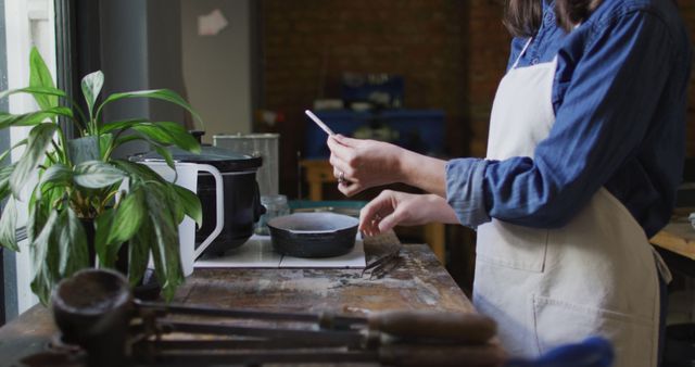 Woman Preparing Food in Rustic Kitchen, Wearing Apron - Download Free Stock Images Pikwizard.com