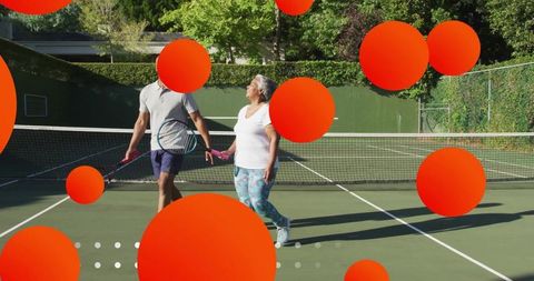 Active Seniors Socializing While Playing Tennis Outdoors