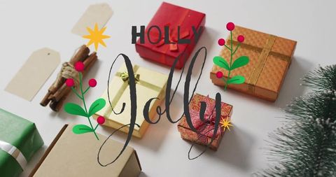 Minimal festive gift flatlay featuring wrapped presents, cinnamon sticks and holly jolly script
