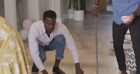 African American Men Tidying Up After Celebration at Home