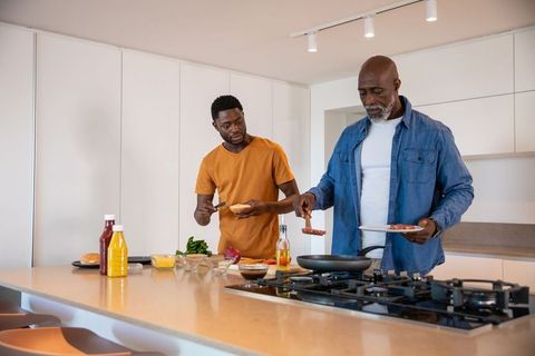 Family Bonding Over Cooking in Modern Kitchen