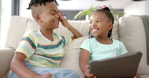 African American Siblings Enjoying Tablet at Home in Playful Mood - Download Free Stock Images Pikwizard.com