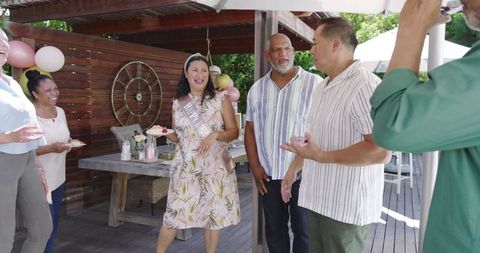 Senior Woman Celebrating with Friends Outdoors