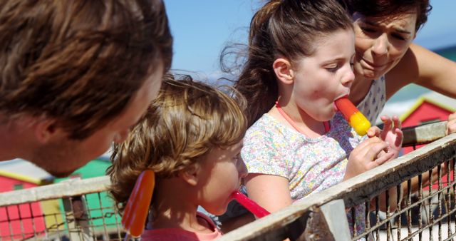 Family Bonding Over Popsicles at Beach - Download Free Stock Images Pikwizard.com